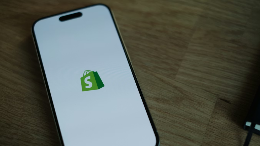 Smartphone showing the Shopify logo for ecommerce shopping.